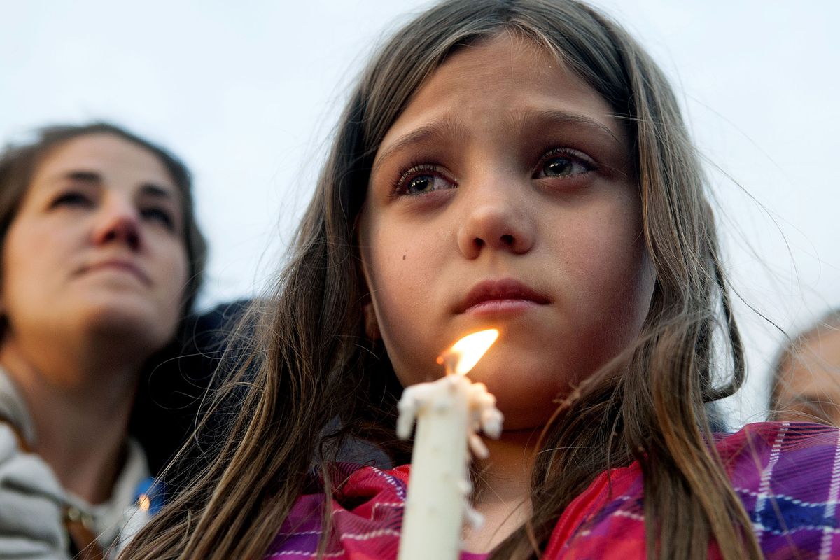 “Mrs. Moore is my teacher,” says Maya Averill, 9, talking about the wife of slain Coeur d’Alene police Sgt. Greg Moore during Tuesday’s candlelight vigil for the 16-year veteran of the department. Moore was shot early Tuesday morning in Coeur d’Alene while checking on a suspicious individual and died Tuesday night at Kootenai Health. (Kathy Plonka)