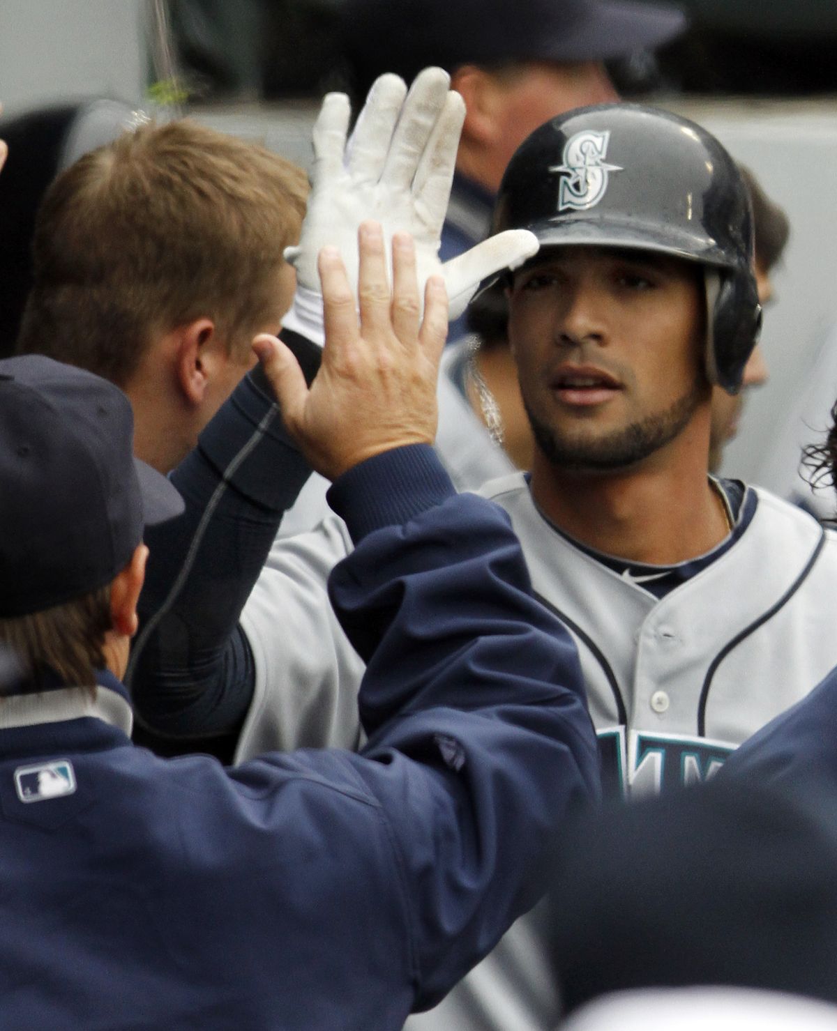 Franklin Gutierrez gets high-fives in the dugout after his fourth-inning home run. (Associated Press)