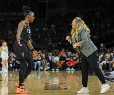The Las Vegas Aces' Chelsea Gray (12) and head coach Becky Hammon confer during a break in third-quarter action against the New York Liberty in Game 2 of the WNBA Finals at Michelob ULTRA Arena on Wednesday, Oct. 11, 2023, in Las Vegas.  (Tribune News Service)