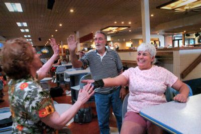 
Rose Laub, left, celebrates a strike with her husband, Dave Laub,  and Rose Mitchell on Wednesday at Sunset Bowl, the large midtown bowling center in Coeur d'Alene that reopened this week. 
 (Jesse Tinsley / The Spokesman-Review)