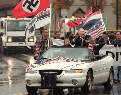 FILE - In this Oct. 28, 2000 file photo, white supremacist Richard Butler, speaks through a megaphone at an Aryan Nations rally  in Coeur d'Alene, Idaho. The Aryan Nations is long gone from northern Idaho, but its reputation lingers to the chagrin of locals. (Tom Davenport / Associated Press)
