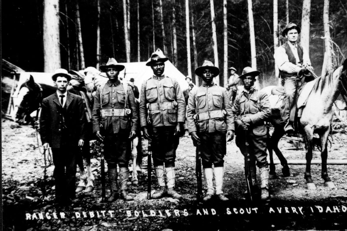 Black troops of the 25th Infantry out of Fort Wright in Spokane were detailed to Avery to fight fire and to maintain order through the hectic days of the 1910 fire. As fires raged around the town, the soldiers partrolled to protect the residents and property in Avery. Ranger Debitt is on the far left. (Photo Forest / Courtesy of U.S. Forest Service)