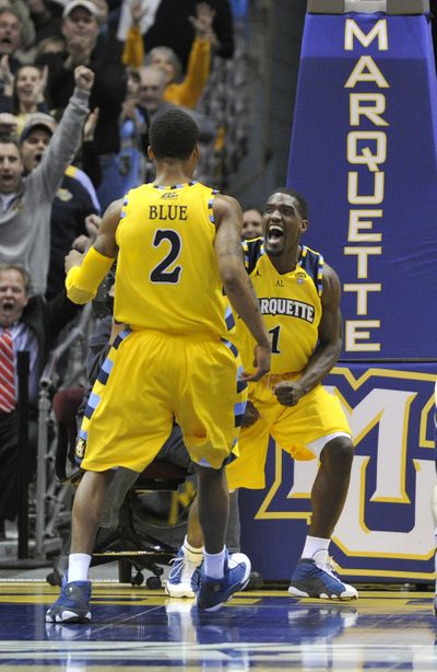 Marquette's Darius Johnson-Odom, right, celebrates a late basket with teammate Vander Blue against Notre Dame. (Associated Press)