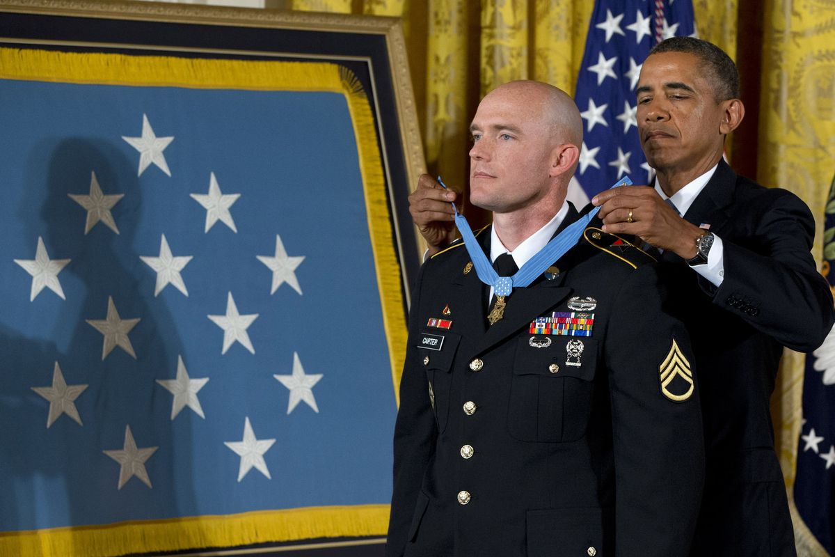 President Barack Obama awards U.S. Army Staff Sgt. Ty Carter, a Spokane native, the Medal of Honor for conspicuous gallantry during a ceremony Monday in the East Room of the White House in Washington. (Associated Press)