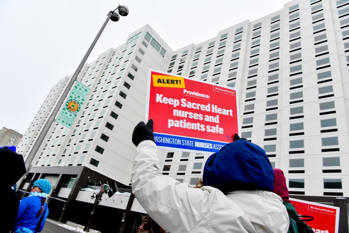 Starla Houff, cheers and carries a sign with other local nurses and concerned citizens in a protest rally on Monday, Feb. 25, 2019, in downtown Spokane, Wash. After little movement from Providence during 7 contract bargaining sessions, Sacred Heart RNs took their concerns about nurse staffing and safe patient care to a rally in Riverfront Park to raise community awareness. (Tyler Tjomsland / The Spokesman-Review)