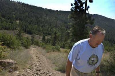 
Ron Knudsen walks a ragged trail made by ORV riders on his property. Riders have done extensive damage to his property in Idaho just outside the Liberty Lake ORV park. 
 (Trinity Hartman / The Spokesman-Review)