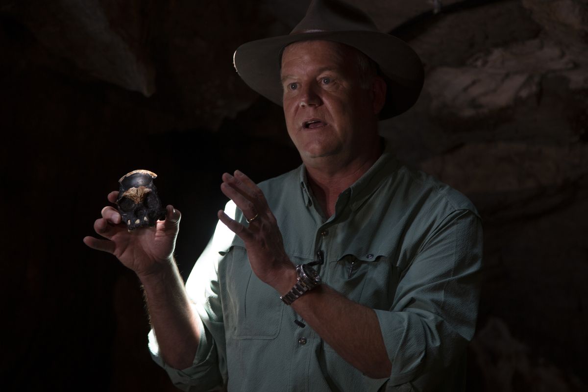 Professor Lee Berger, from the University of the Witwatersrand, holds a replica of the discovered Homo Naledi fossil inside the Rising Star Cave in the Cradle of Humankind World Heritage Site near Johannesburg, Thursday, Nov. 4, 2021. Homo naledi is a species of archaic human discovered in the Rising Star Cave, Cradle of Humankind, South Africa dating to the Middle Pleistocene 335,000–236,000 years ago.  (Denis Farrell)