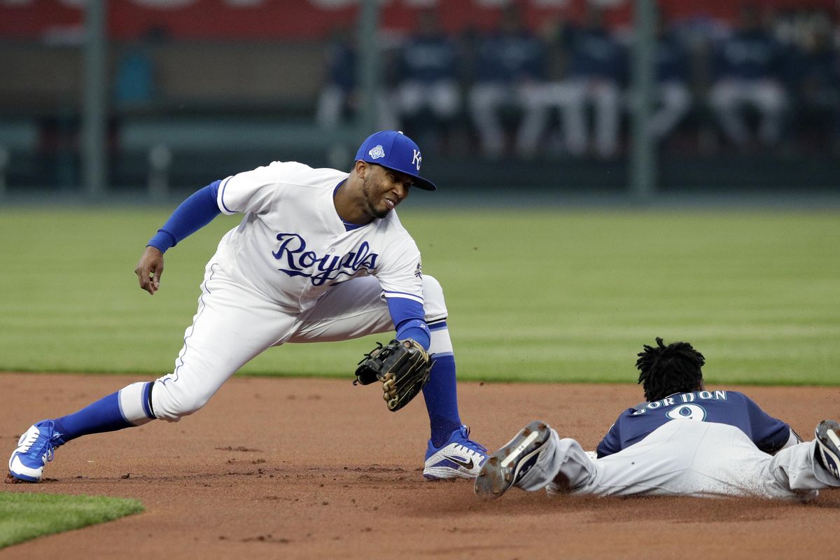 Seattle’s Dee Gordon beats the tag by Kansas City shortstop Alcides Escobar during the first inning  Tuesday in Kansas City, Missouri. Gordon was safe on the play with a stolen base. (Orlin Wagner / AP)