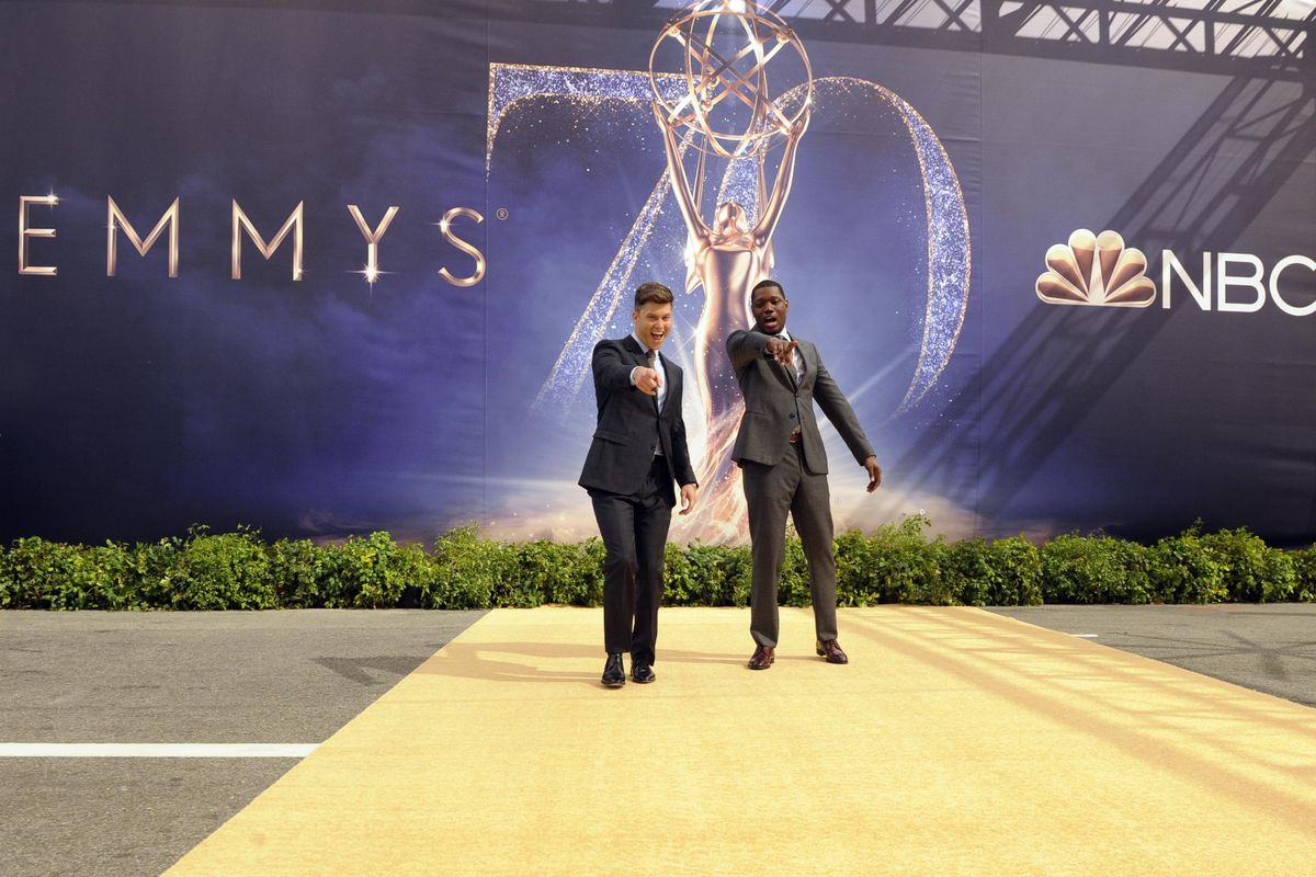 Colin Jost, left, and Michael Che, co-hosts for the 70th Emmy Awards, react after rolling out the gold carpet outside the Microsoft Theatre on Thursday in Los Angeles. (Chris Pizzello / Associated Press)