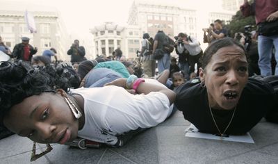 Protesters lie in a mock arrest pose during a demonstration  Wednesday against the shooting death of Oscar Grant in Oakland, Calif.  (Associated Press / The Spokesman-Review)