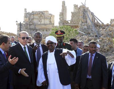 Turkey’s President Recep Tayyip Erdogan, second left, and Sudan’s President Omar al-Bashir, center, walk in Port Sudan, Sudan, Dec. 25, 2017. Sudan’s armed forces were to deliver an “important statement” and asked the nation to “wait for it” on Thursday, April 11, 2019, state TV reported, as two senior officials said the military had forced longtime President Omar al-Bashir to step down. (Kayhan Ozer / Associated Press)