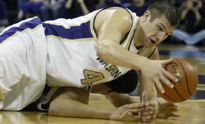 
Washington's Jon Brockman lands on top of Oregon State's Kyle Jeffers while chasing a loose ball on Thursday night. 
 (Associated Press / The Spokesman-Review)