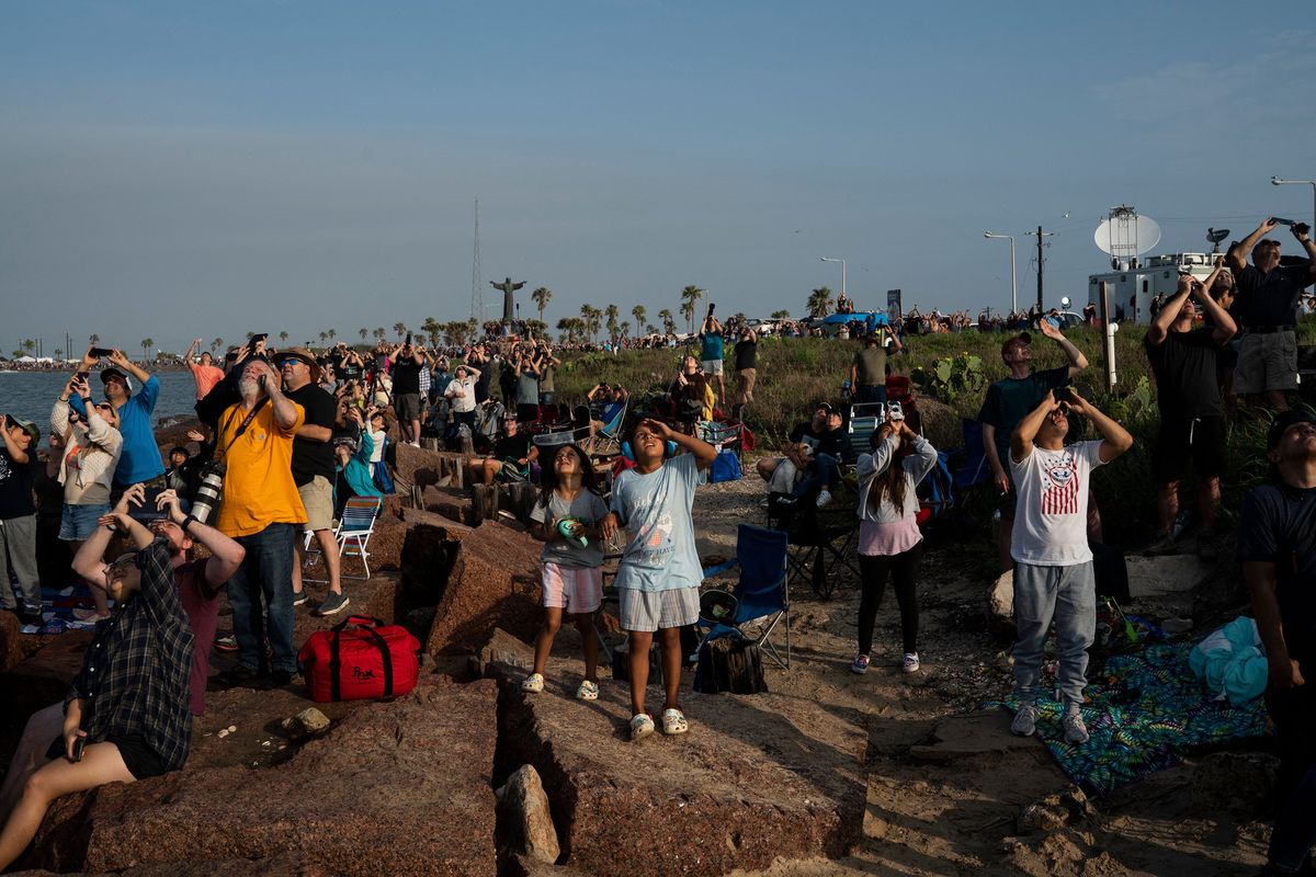 Spectators watch from South Padre Island, Texas, as the SpaceX Starship launches for a flight test from Starbase in Boca Chica, Texas, on April 20, 2023. The Starship exploded during the first test flight of the spacecraft. The rocket successfully blasted off at 8:33 am Central Time (1333 GMT). The Starship capsule had been scheduled to separate from the first-stage rocket booster three minutes into the flight but separation failed to occur and the rocket blew up.    (Veronica G. Cardenas/AFP/Getty Images)