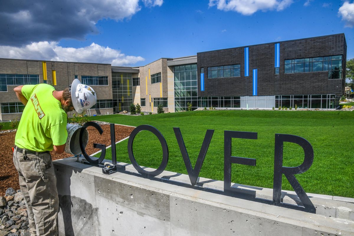 Seth Matthews, of Jackson Contractor group, pours cement into the base of the new Glover Middle School sign Monday in Spokane.  (DAN PELLE/THE SPOKESMAN-REVIEW)