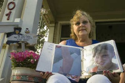 
Marvel Nichols sits on the front porch of her Spokane home with photo of Marita Ulaj, whom Nichols wants to bring from Albania for medical treatment. 
 (Christopher Anderson / The Spokesman-Review)