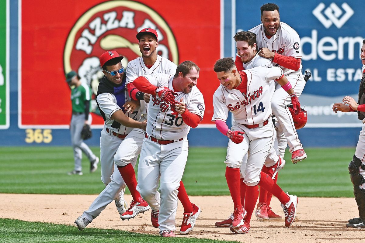 Spokane Indians infielder Colin Simpson (center) celebrates with teammates after his 10th-inning single gave the Indians a 1-0 win over Eugene on Tuesday, May 17, 2022.  (James Snook/FOR THE SPOKESMAN-REVIEW)