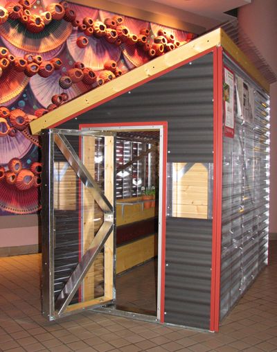 This is one of the 12 custom-built playhouses that will be auctioned or raffled off at the Spokane Premier Home Improvement Show at the fairgrounds on Saturday. Built by Band Construction, this playhouse is on display in the lobby at City Hall. (Pia Hallenberg)