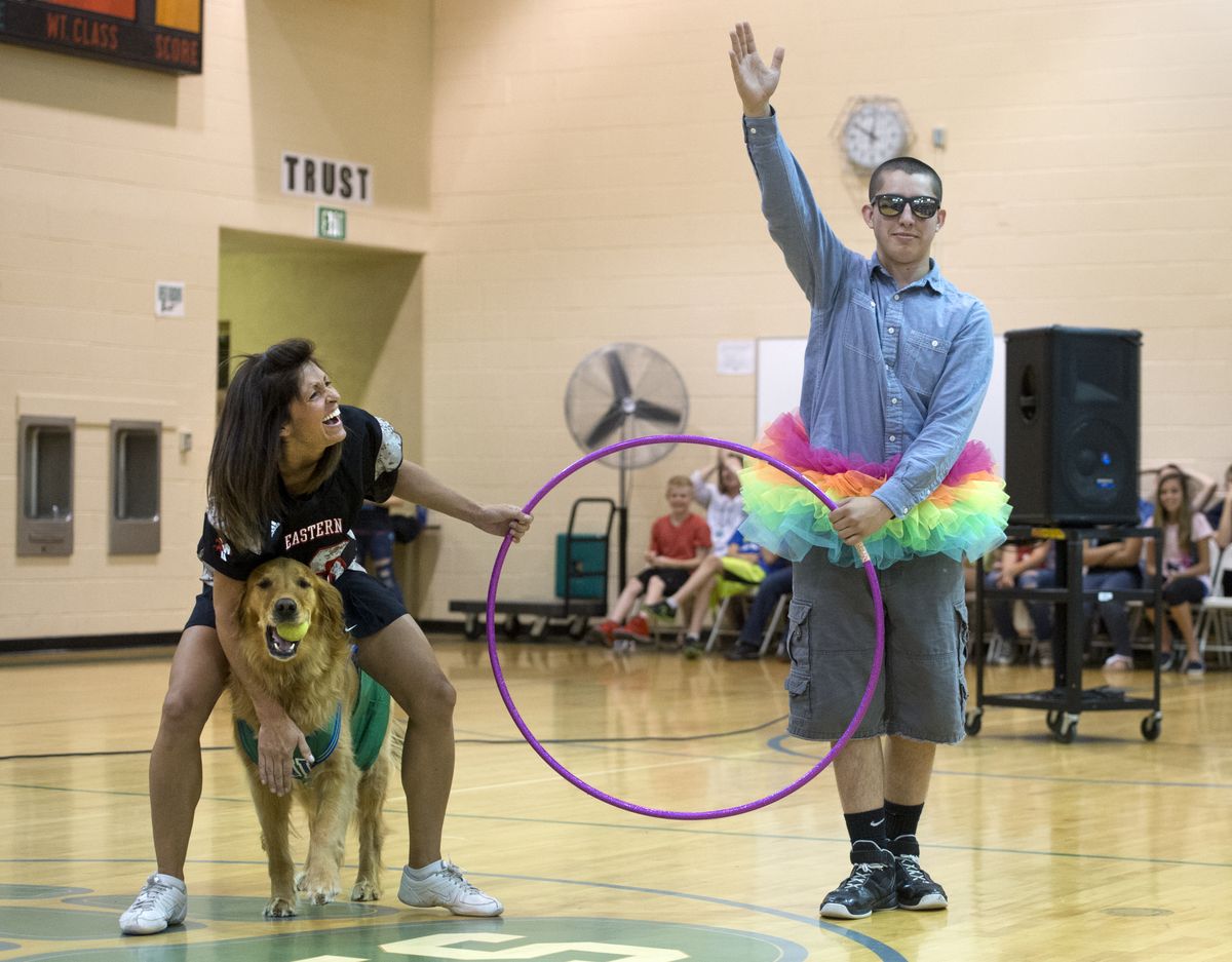 Greenacres Middle School eighth-grader Zach Windhorst salutes Friday after performing with teacher Dana Hilpert and her dog Murphy. (Dan Pelle)