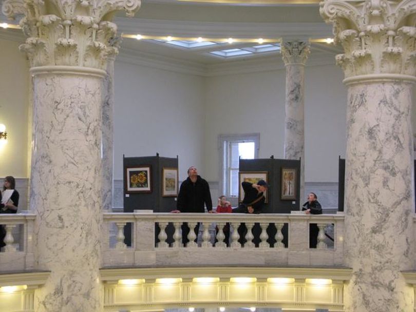 Families with kids out of school are among the many visitors at the Statehouse on Monday, President's Day, as the Legislature continued its session and an annual watercolor art show opened in the 4th floor rotunda. (Betsy Russell)