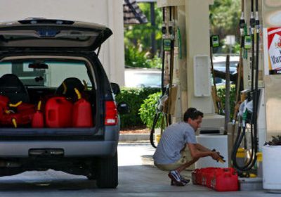 
Eugenio Duarte, of Coconut Grove, Fla., fills up gas cans in anticipation of the arrival of Tropical Storm Ernesto on Monday. 
 (Associated Press / The Spokesman-Review)