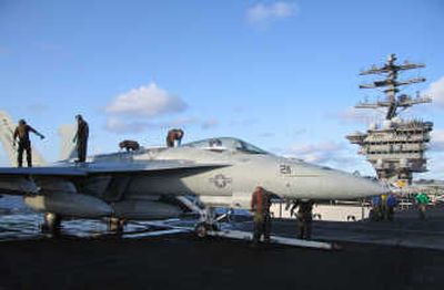 
Airmen maintain an F/A-18E Hornet, flown by Strike Fighter Squadron 14 (VFA-14) aboard the USS Nimitz in May 2005. PBS
 (PBS / The Spokesman-Review)