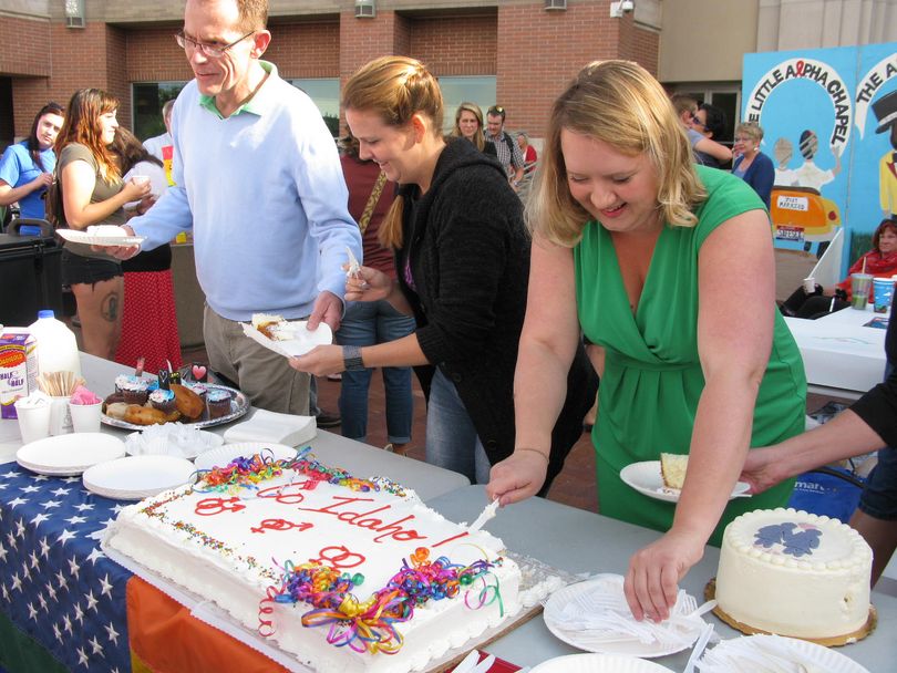 Organizer Emily Walton, right, serves cake at a gathering to support same-sex marriage on the Ada County Courthouse steps Friday morning; the party originally was planned as a wedding reception, until an appeals court late Thursday stayed a federal court order that would have legalized gay marriage in Idaho as of 9 a.m. Friday. (Betsy Russell)
