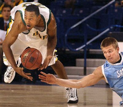 
San Diego center Nick Lewis, right, reaches in to disrupt San Francisco forward Alan Wiggins Jr.
 (Brian Plonka / The Spokesman-Review)