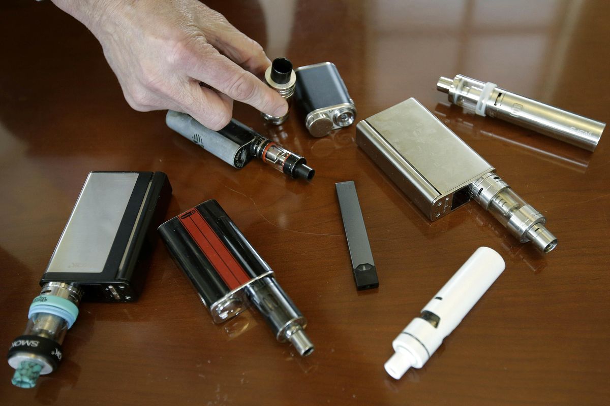 A high school principal displays vaping devices that were confiscated from students in such places as restrooms or hallways at the school in Massachusetts. (Steven Senne / Steven Senne/Associated Press)