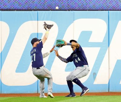 Seattle Mariners center fielder Julio Rodriguez nearly collides with Seattle Mariners left fielder Jesse Winker, who catches a fly ball off of Cleveland Guardians left fielder Steven Kwan in the seventh inning.  (Tribune News Service)