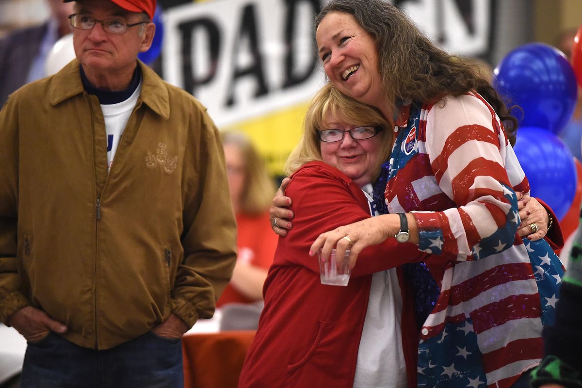 Trump supporters Judy Van Houten, center, and Judy Crowder, right, hug after television cable news announced that Donald Trump had gone over the 270 electoral votes needed to clinch the presidency, Tuesday, Nov. 8, 2016 at CenterPlace in Spokane Valley. At left is Van Houten