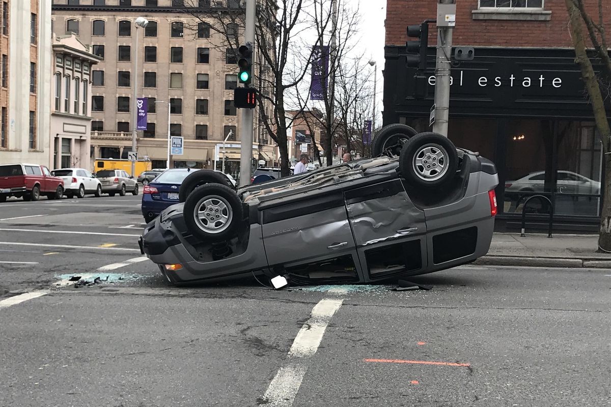 A driver escaped mostly uninjured after a truck running a red light clipped him while he was headed south on Stevens Street in downtown Spokane on Monday, Feb. 2, 2018. (Jonathan Glover / The Spokesman-Review)