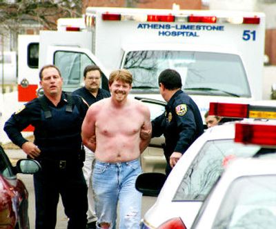 
Farron Barksdale is taken to a squad car in Athens, Ala. in this Friday, Jan. 2, 2004, file photo, after allegedly shooting two Athens police officers. Barksdale had been committed involuntarily to mental hospitals on at least two occasions. 
 (File/Associated Press / The Spokesman-Review)