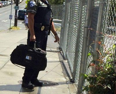 This photograph, taken June 10 by Ann Wagner, an off-duty federal public defender, has fueled social media rumors that immigration agents are prowling Sound Transit stations. Wagner was waiting with her toddler for a bus at the Capitol Hill light-rail train station when she photographed a security guard at a station gate with an Immigration and Custom’s Enforcement (ICE) card clearly visible in a window on his duffel bag. (Ann Wagner)