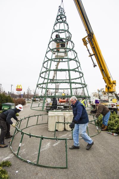 Volunteers with the Rotary of Spokane Valley, with help from a Modern Electric crew, set a Christmas tree in the parking lot of the old U-City Mall Monday, Nov. 30, 2015. (Colin Mulvany / The Spokesman-Review)