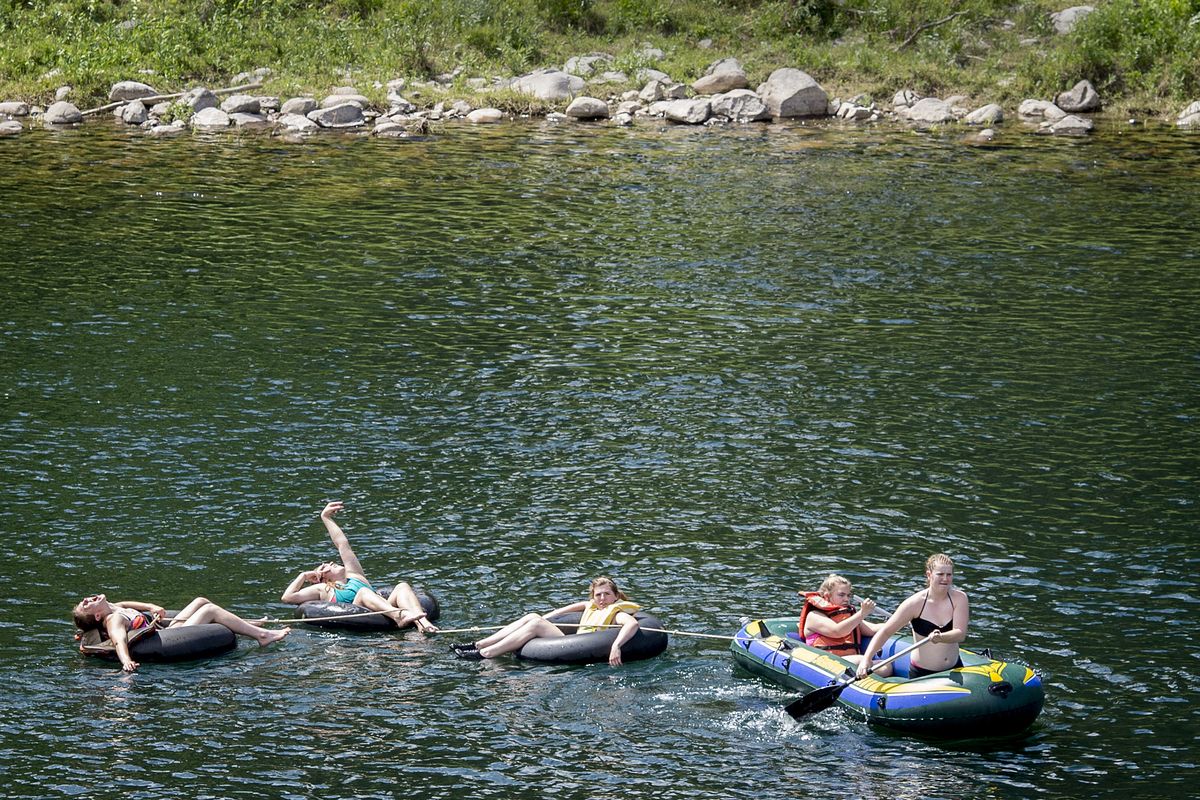 High school girls basketball players from Amity, Oregon, take a break from a local camp to float the Spokane River below the Bowl and Pitcher in Riverside State Park on Wednesday. Water pollution will impact proposed fish-consumption levels. (Colin Mulvany)