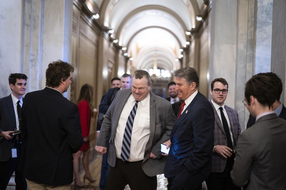 Sen. Jon Tester (D-Mont.) nudges Manchin as they joke around on Capitol Hill on March 7. MUST CREDIT: Washington Post photo by Jabin Botsford  (Jabin Botsford/The Washington Post)