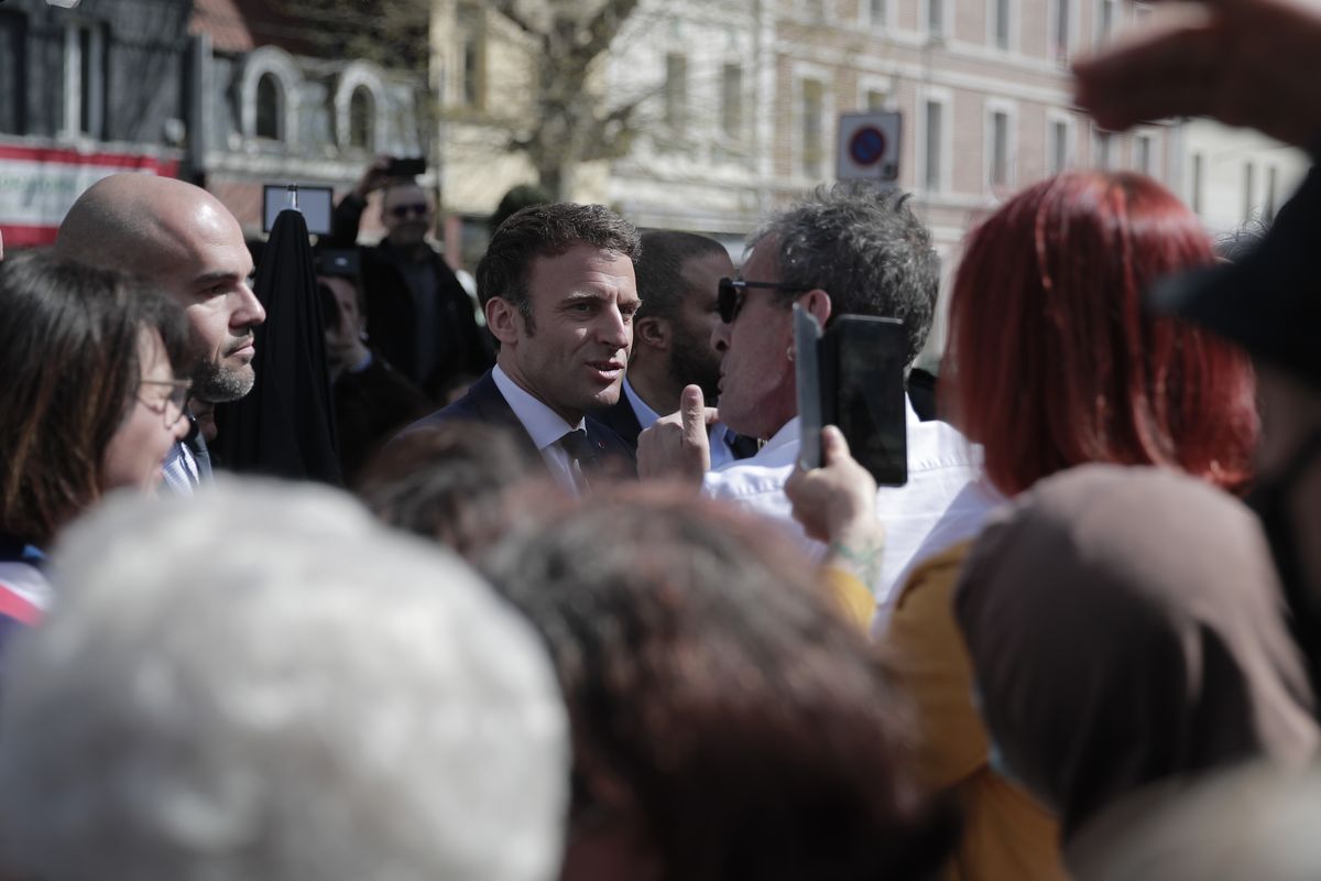 Current French President and centrist presidential candidate for reelection Emmanuel Macron meets residents in Denain, northern France, Monday, April 11, 2022 . French President Emmanuel Macron may be ahead in the presidential race so far, but he warned his supporters that "nothing is done" and his runoff battle with far-right challenger Marine Le Pen will be a hard fight.  (Lewis Joly)