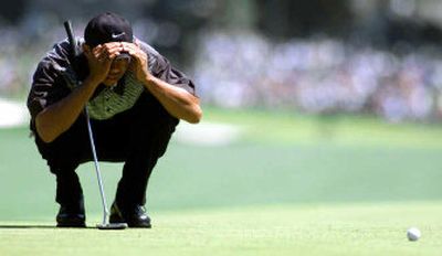 
Tiger Woods studies a putt on the first hole during the 2000 Masters. No. 1, which has been lengthened to 455 yards, is one of several holes at Augusta National that has been upgraded in the past several years.
 (File/Associated Press / The Spokesman-Review)