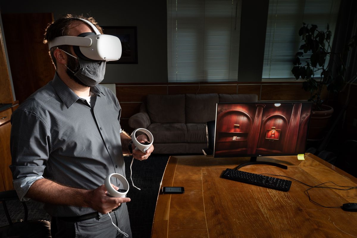 At Cyan Worlds near Mead, Spokesman-Review reporter Kip Hill plays Myst on Wednesday. A new, updated version of the 1993 classic video game now includes virtual reality support.  (COLIN MULVANY/THE SPOKESMAN-REVI)
