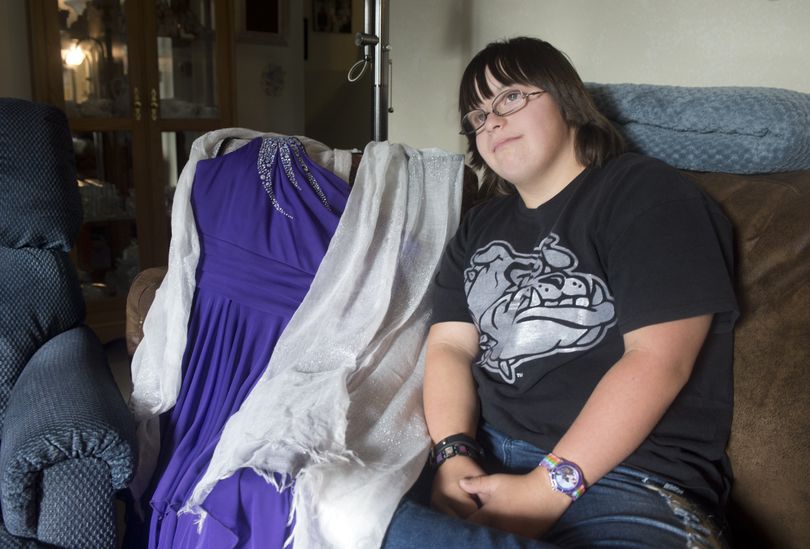 Tiffany Allen, who has Down Syndrome, sits beside the formal dress she will wear as she vies for homecoming princess at East Valley High School. (Jesse Tinsley)