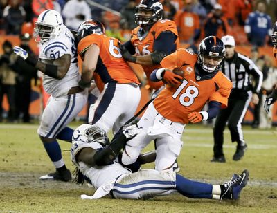 Broncos quarterback Peyton Manning is sacked by Colts outside linebacker Erik Walden during the second half. (Associated Press)