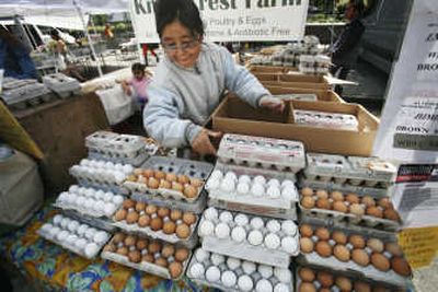 
Wang Mo stacks eggs in the Union Square market on Wednesday in New York. Inflation pressures eased in April despite the biggest jump in food prices in 18 years. Associated Press
 (Associated Press / The Spokesman-Review)