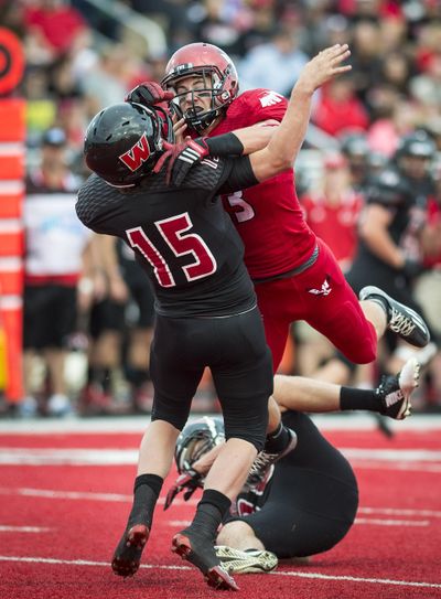 Eastern defensive lineman Marcus Saugen levels Montana Western quarterback Tyler Hulse in a 2014 game on Roos Field in Cheney. Saugen, who played high school football at North Central, says the defense needs to regain its toughness. (Colin Mulvany / The Spokesman-Review)