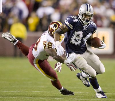 Washington linebacker London Fletcher attempts to stop Dallas running back Marion Barber in the first quarter. (Associated Press / The Spokesman-Review)