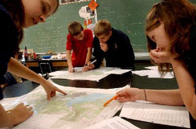 
Charter Academy eighth-graders, from left, Dominique Billingslea, David Clampet, Cameron Crandall and Callie Anderson, work with topographic maps  during their Earth science class. 
 (Kathy Plonka / The Spokesman-Review)