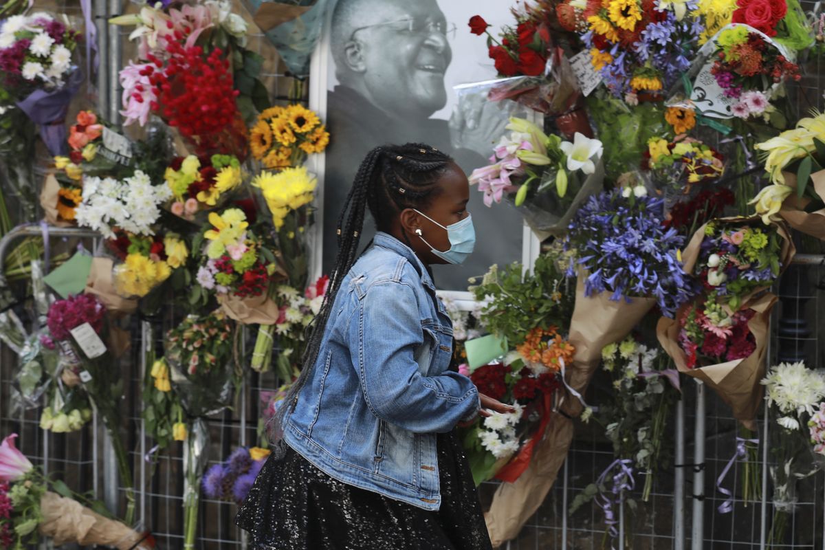 A woman places a floral tribute outside the St. George