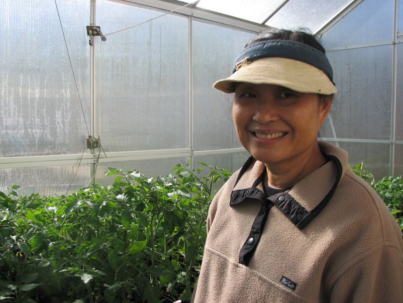 Virginia Kanikeberg is standing in her backyard green house surrounded by tomato plants. She's a member of The Inland Empire Gardeners Club and giving away surplus plants for free to community gardens.