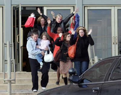 
Shoppers  exit the Von Maur store after a man opened fire with a rifle at the Westroads Mall  on Wednesday in Omaha, killing eight people before taking his own life.  
 (Associated Press photos / The Spokesman-Review)