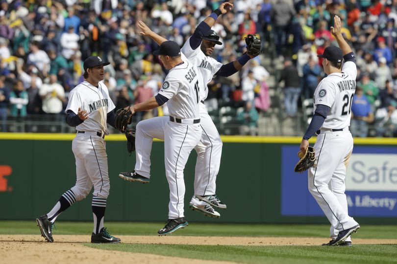 Mariners Kyle Seager and Robinson Cano are in a celebratory mood after 4-1 win. (Associated Press)