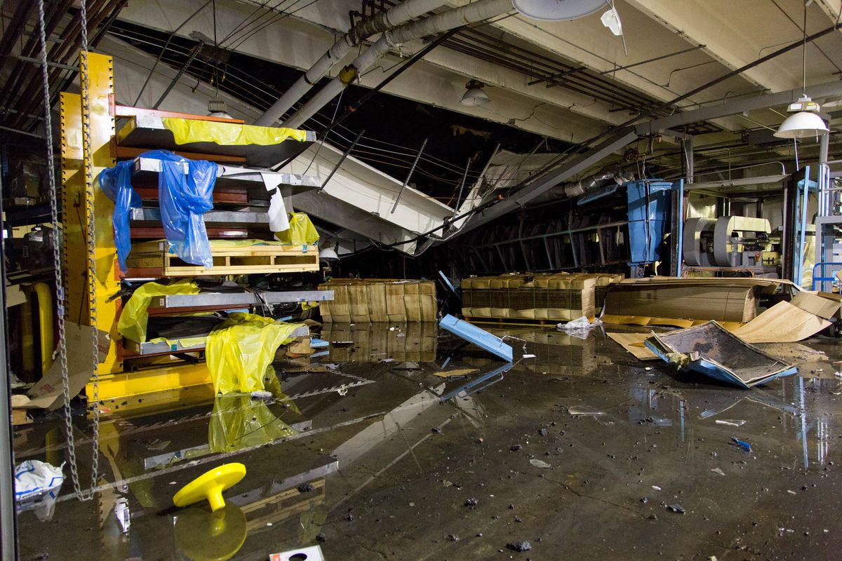 An explosion in July 2015 caused part of the roof of Zodiac Aerospace, in Newport, to cave in. “The damage done there is incredible,” said Assistant Spokane Fire Chief Brian Schaeffer. “On the other side of the building there are doors that are blown off their hinges.” (Eli Francovich/The Spokesman-Review)